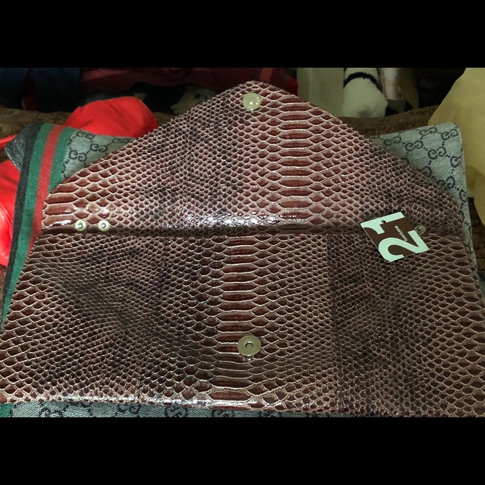 Faux snakeskin sleek clutch New w tag 15 inches